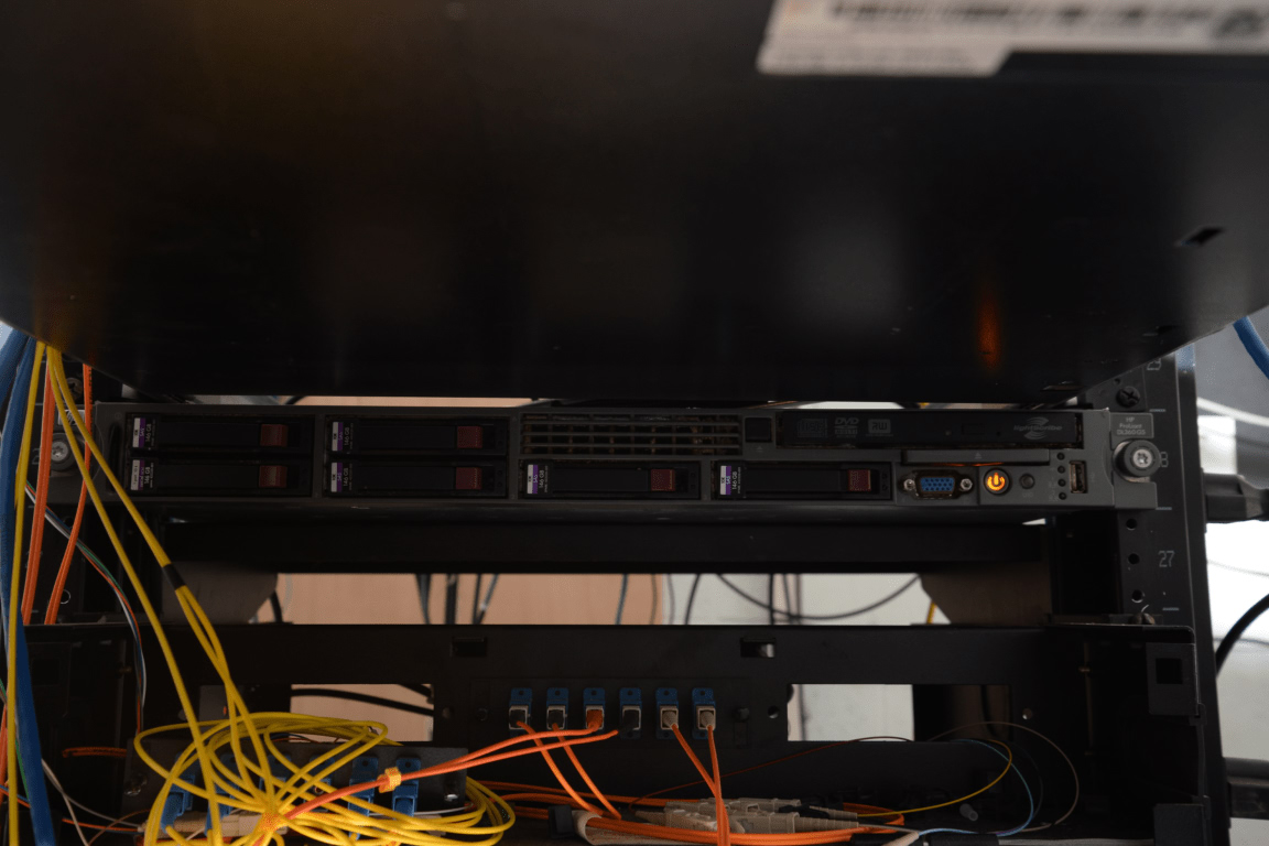 Data center server rack with networking equipment and cabling.